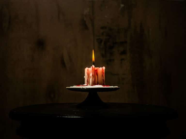 a lit candle sitting on top of a table