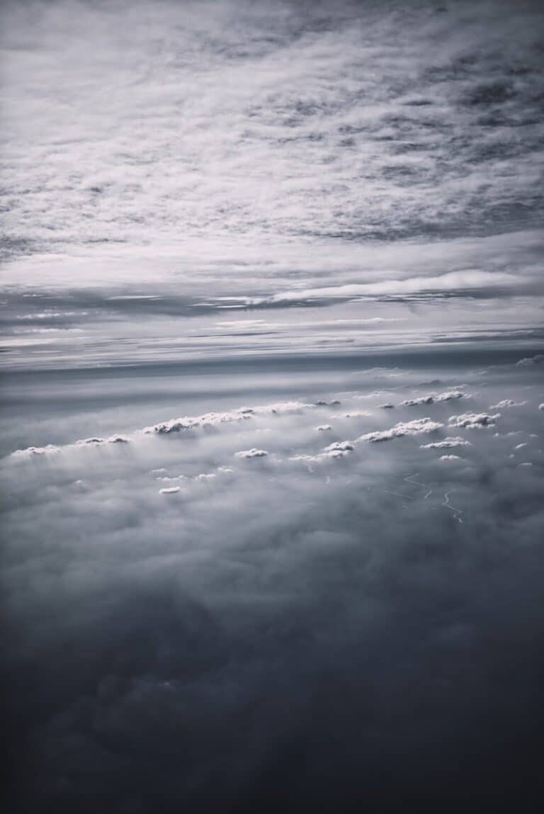 a black and white photo of clouds in the sky
