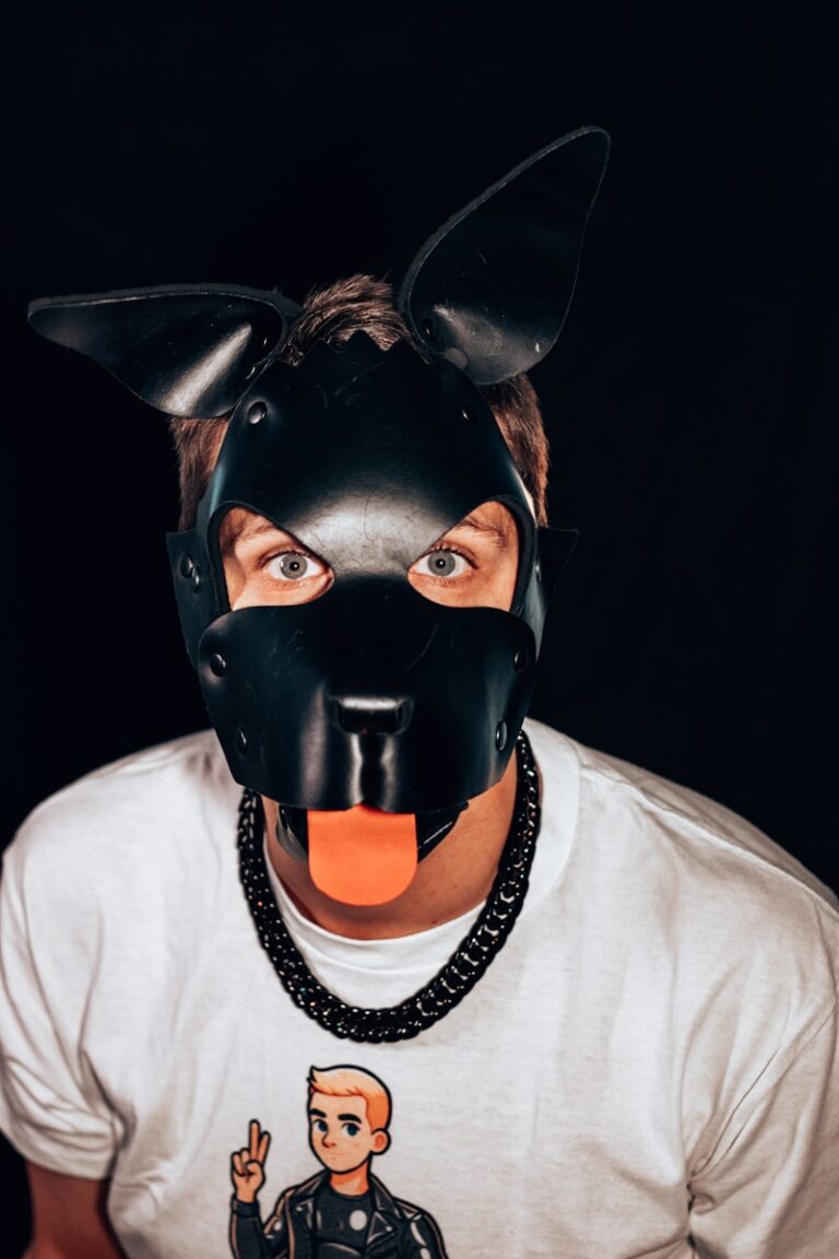 A man wearing a black mask with an orange tongue