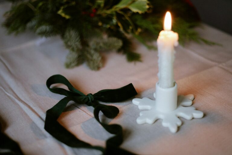 A white candle sitting on top of a table