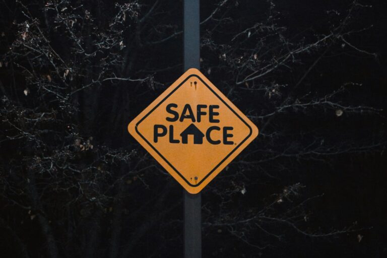 A yellow sign that says safe place on it